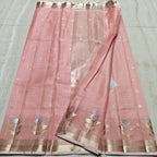 Pink saree with gold patterns on a light gray background