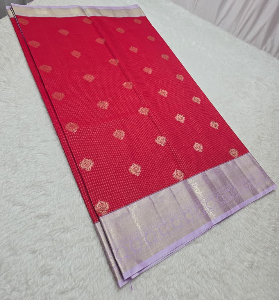 Red saree with a white border on a light gray background