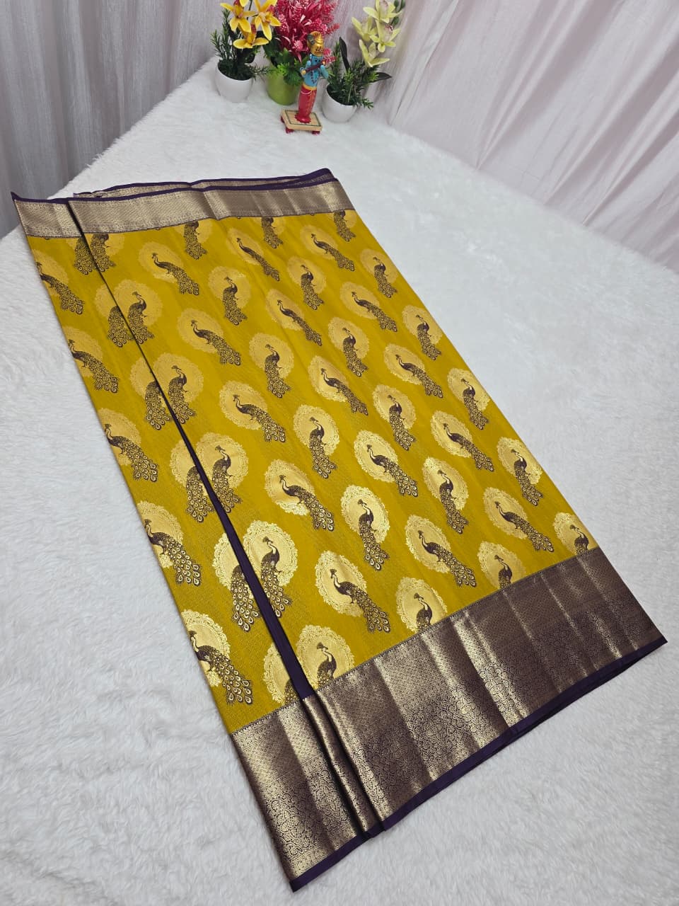Yellow saree with a pattern on a white background