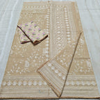 Beige fabric with white floral embroidery on a tiled floor
