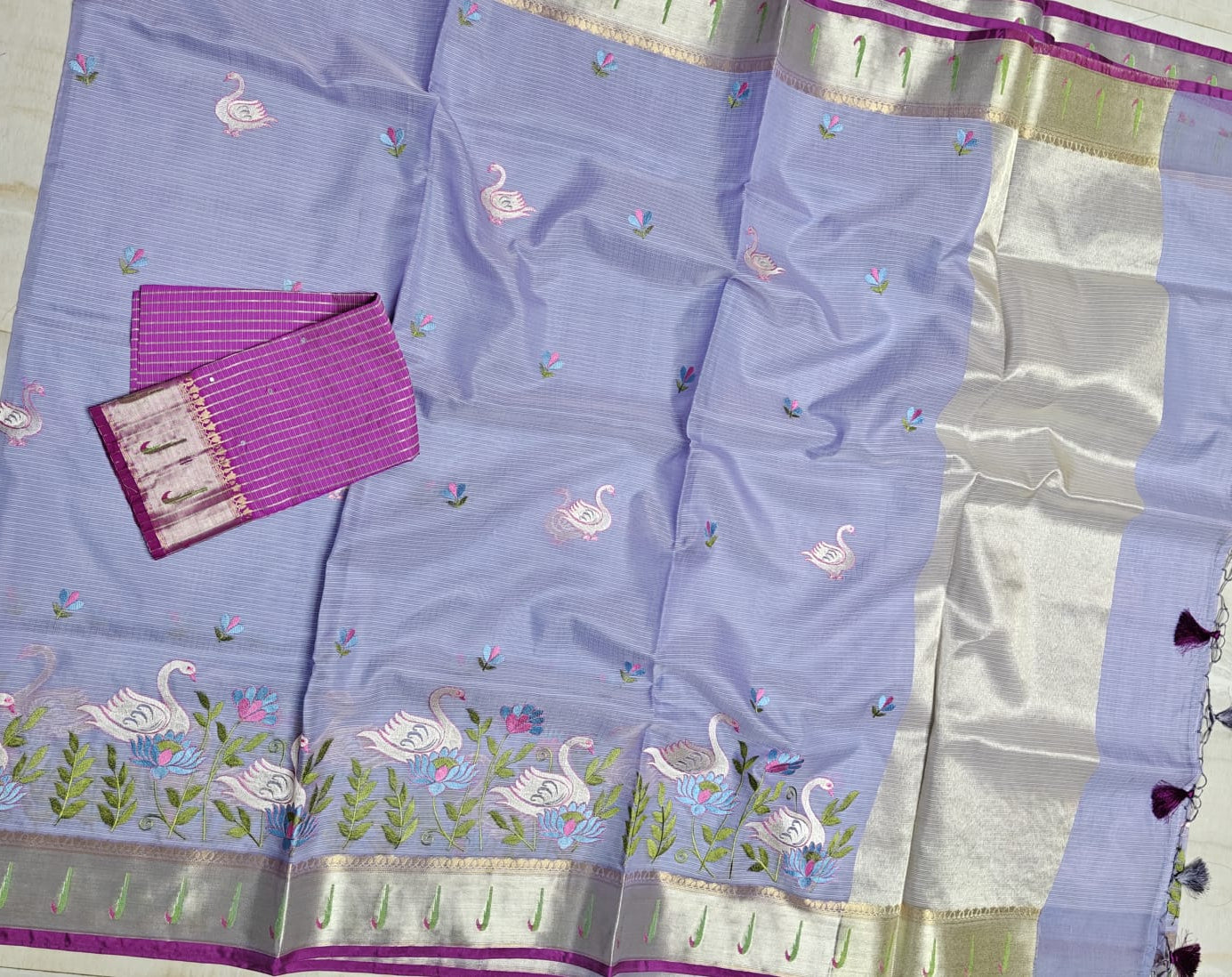 Traditional saree with intricate patterns on a light blue fabric.