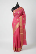 Pink saree with gold patterns on a light gray surface