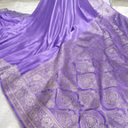 Purple saree with intricate silver patterns on a white background