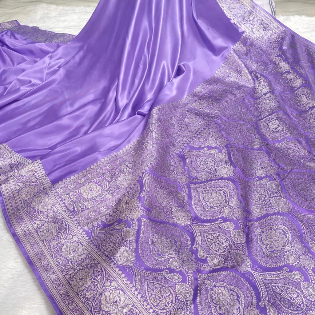 Purple saree with intricate silver patterns on a white background
