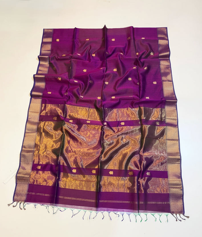 Purple and gold saree with decorative elements on a white background