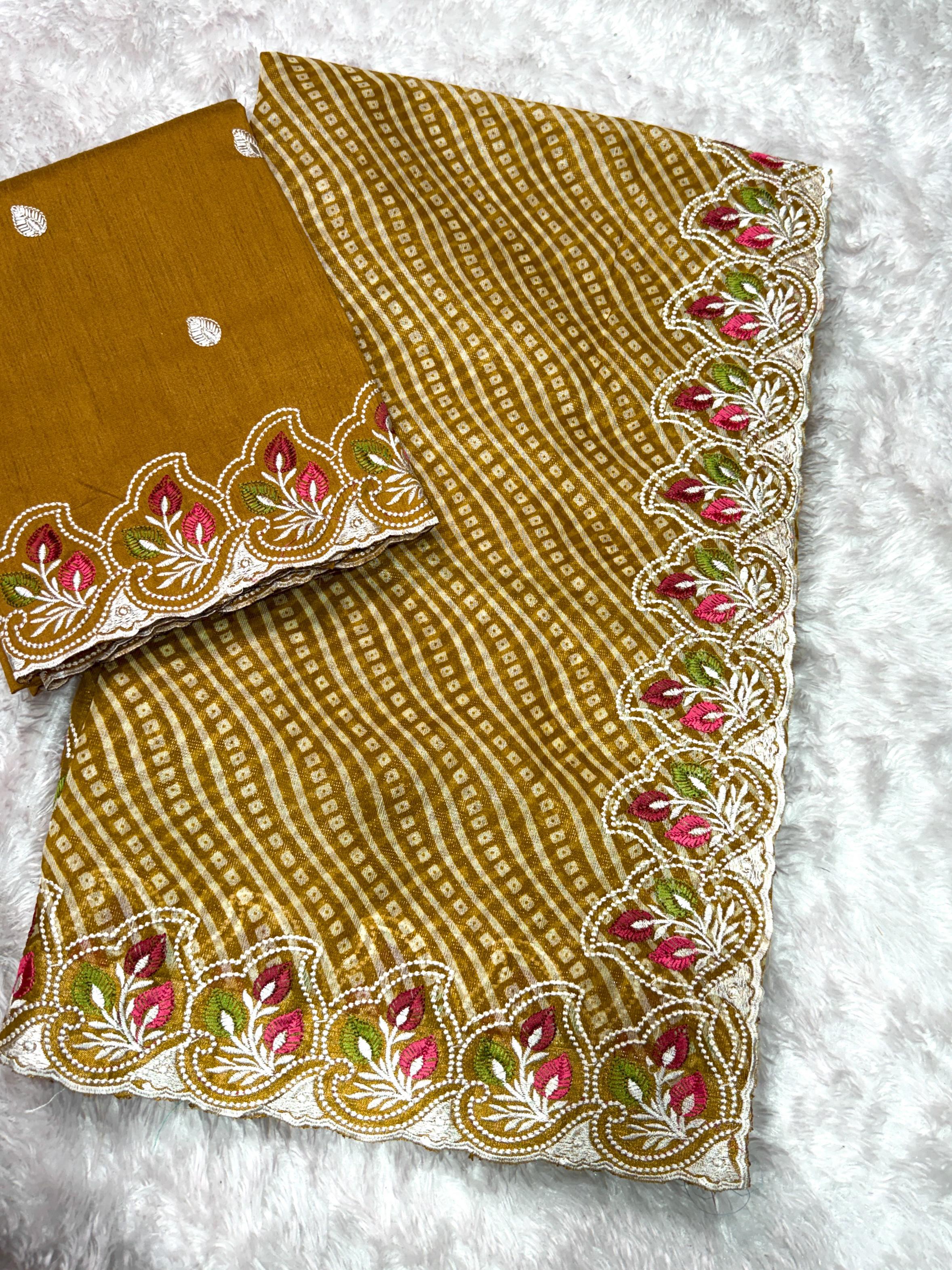 Mustard yellow fabric with floral embroidery on a white background