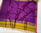 Purple and yellow saree with a floral decoration on a white background