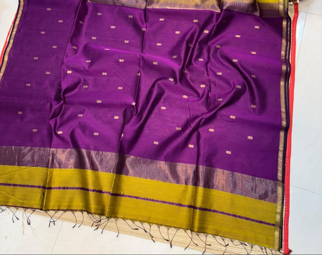 Purple and yellow saree with a floral decoration on a white background