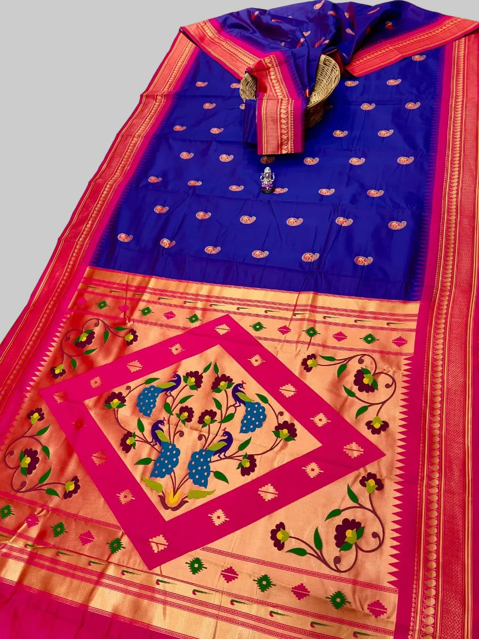 Colorful saree with intricate patterns on a plain background