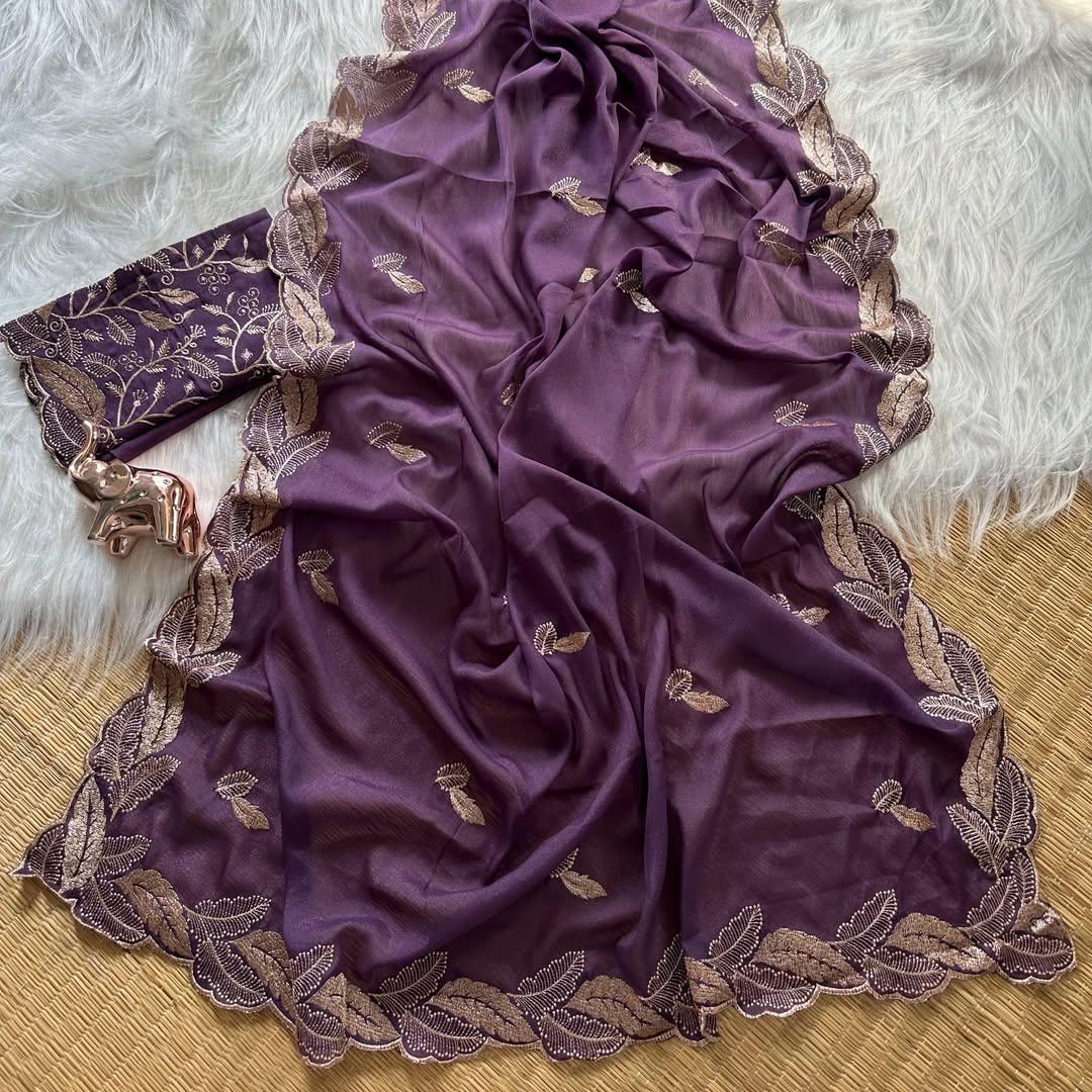 Purple fabric with gold embroidery on a textured surface