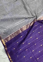 Textile with striped pattern on top and purple fabric with gold accents on the bottom.