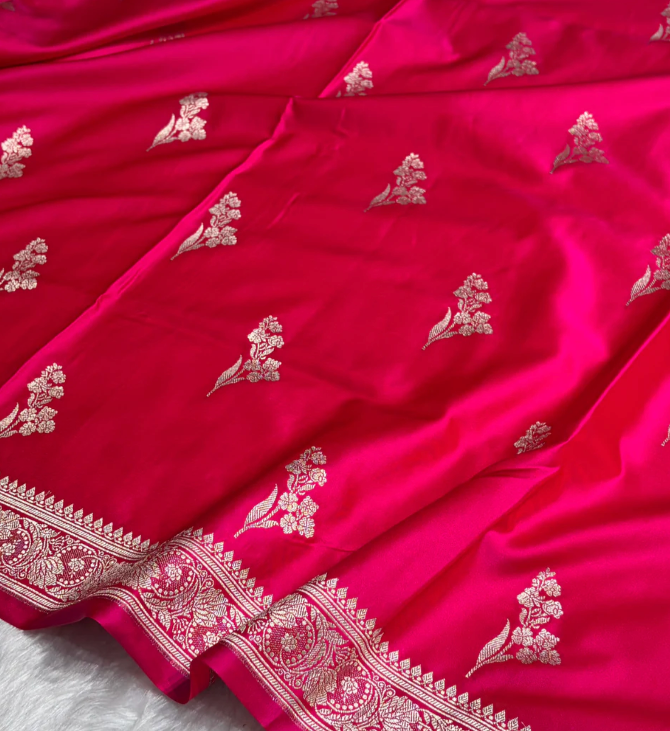 pink fabric with white floral embroidery on a white background