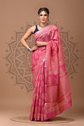 Woman wearing a pink saree with a decorative background