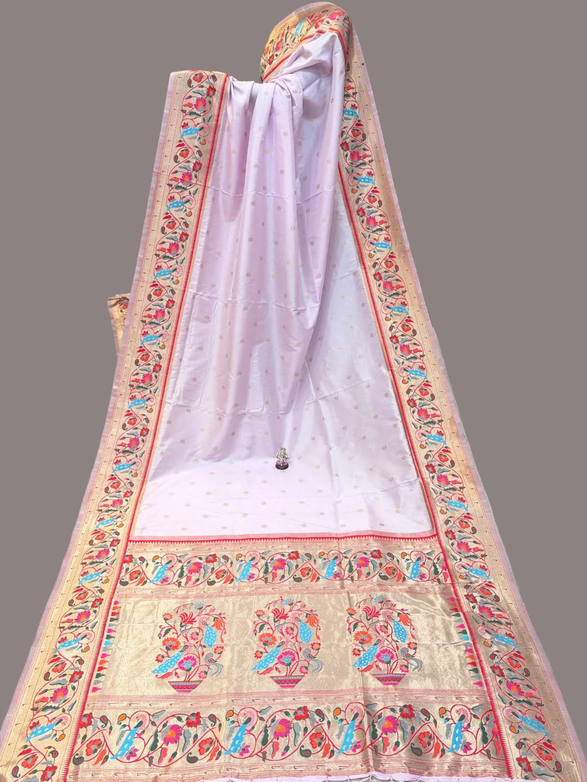 Decorative saree with colorful patterns in a store setting