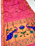 Saree with pink and orange design featuring peacocks and flowers on a white background