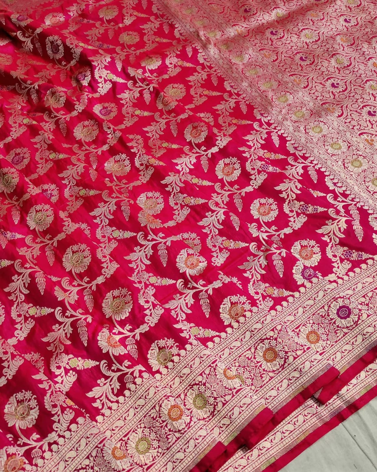 Red fabric with intricate white floral patterns