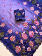 Purple Tebby silk saree with pink lotus digital floral prints, green leaf motifs, gold-tone Katdana detailing, scalloped edges and a matching running blouse.
