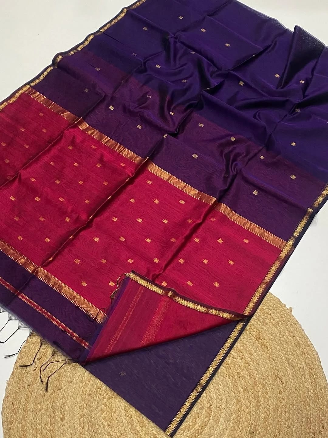 Purple and red saree with gold border on a white background