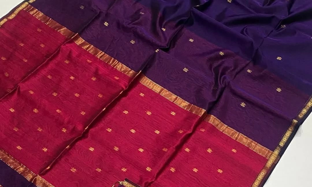 Purple and red saree with gold border on a white background