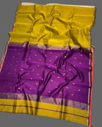 Purple and yellow saree with a floral decoration on a white background