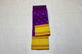 Purple and yellow saree with floral decorations on a light gray background