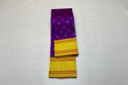 Purple and yellow saree with floral decorations on a light gray background