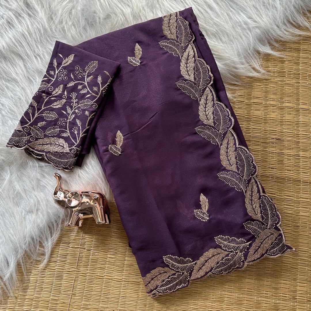 Purple fabric with gold embroidery on a textured surface