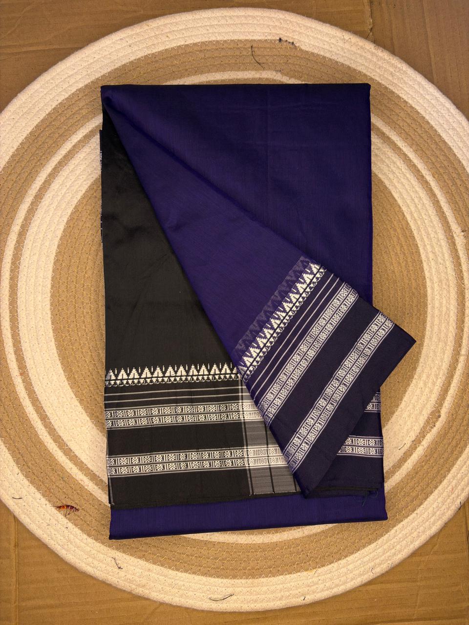 Purple and black fabric with white patterns on a wooden surface