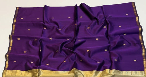 Purple and gold saree with a basket of flowers on a white background