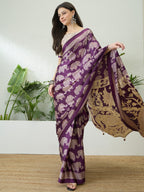 Woman wearing a purple saree with elephant patterns in a minimal indoor setting