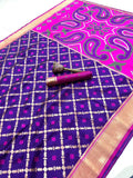 Purple and pink patterned fabric with a decorative item on a white background