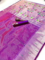Purple saree with floral patterns and a decorative roll on a white background