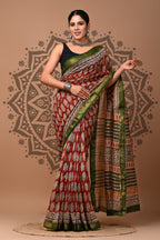 Woman wearing a traditional saree with a patterned background