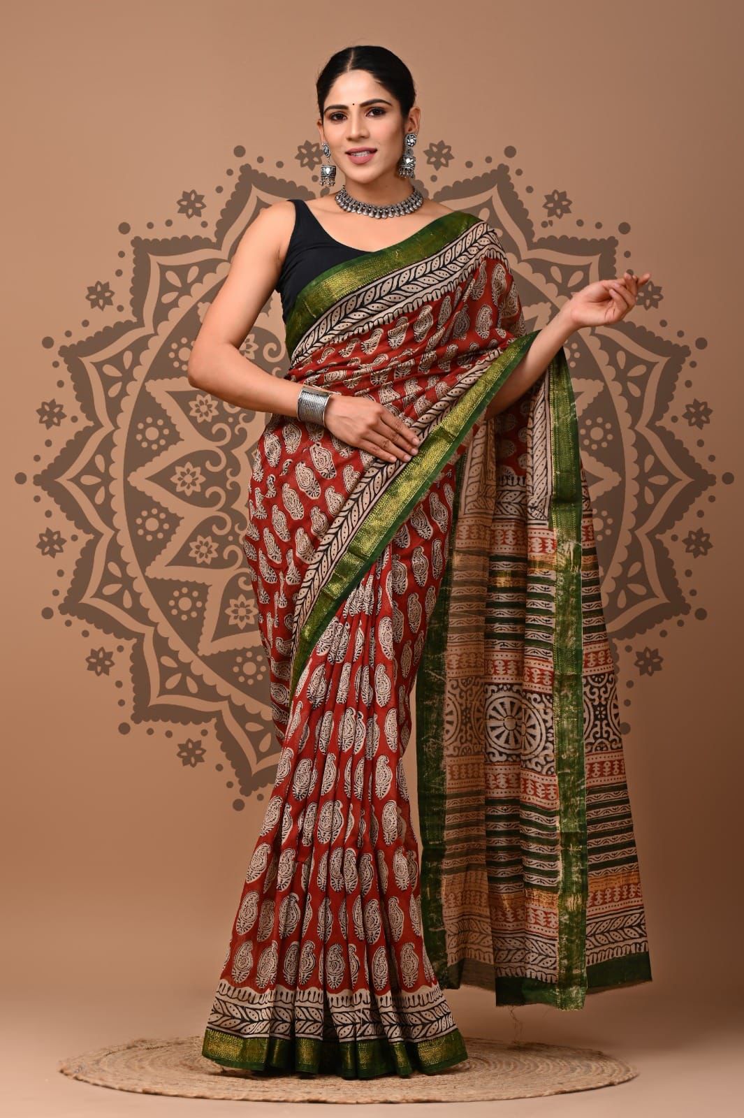 Woman wearing a traditional saree with a patterned background