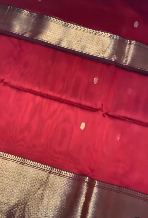 Close-up of a red fabric with gold border