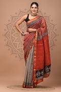 Woman wearing a traditional saree with a decorative background