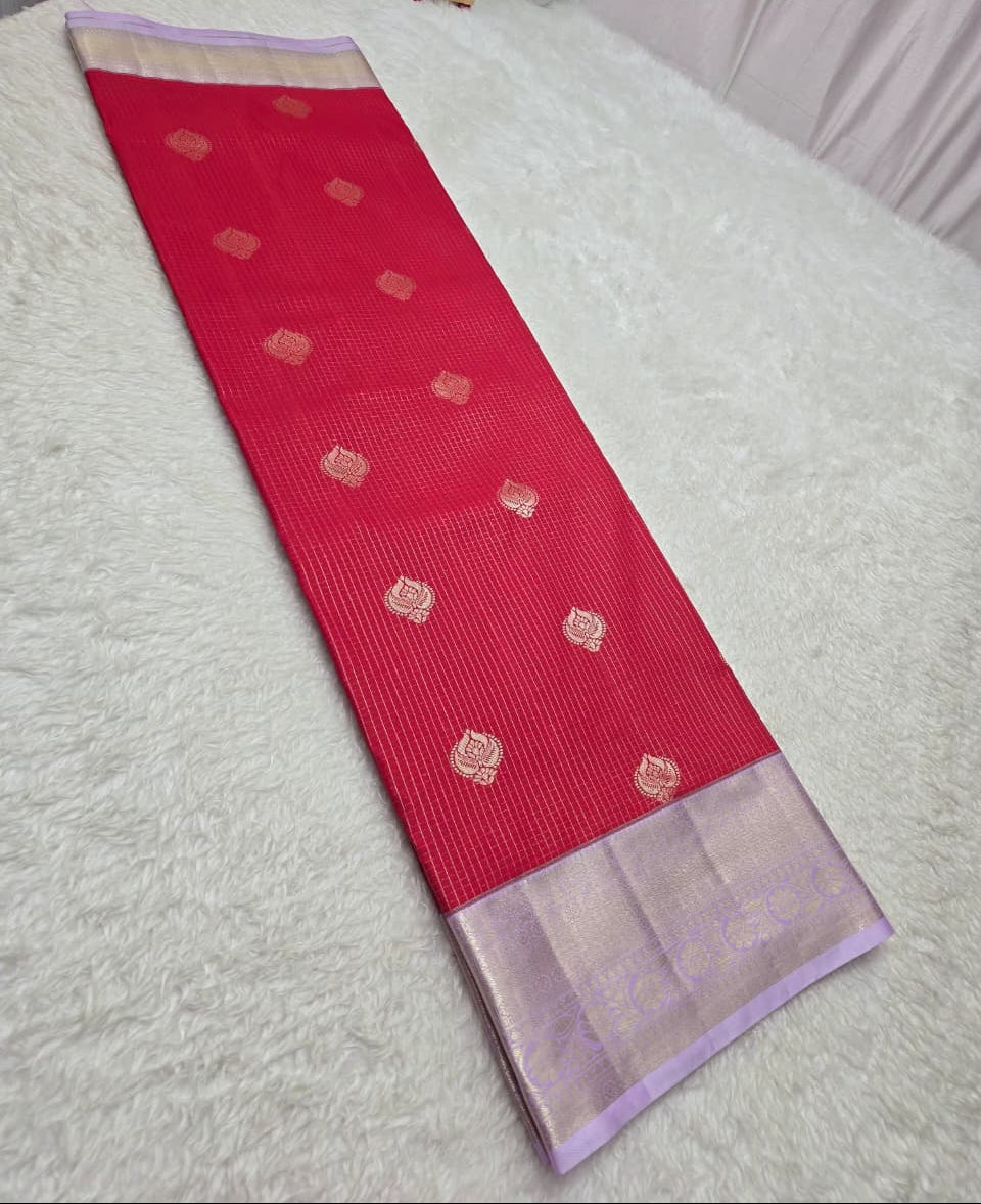 Red saree with gold patterns on a white surface