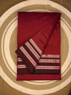 Red fabric with a pattern on a circular woven mat