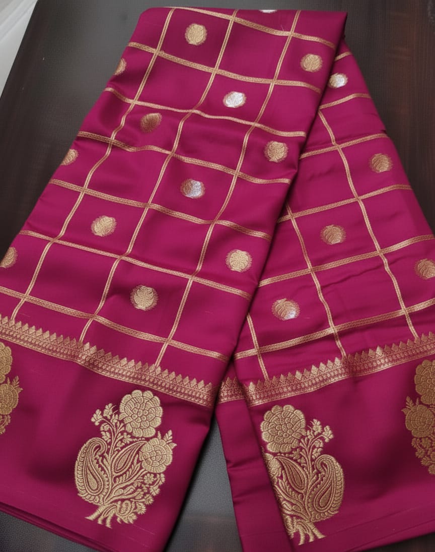 Pink saree with gold patterns on a dark surface