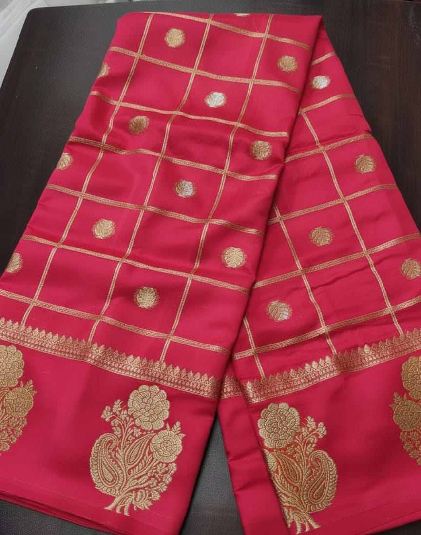 Red fabric with gold patterns on a dark surface