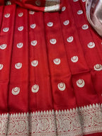 Red fabric with white patterns, possibly a traditional garment