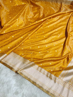 Close-up of a yellow fabric with white patterns on a light blue background