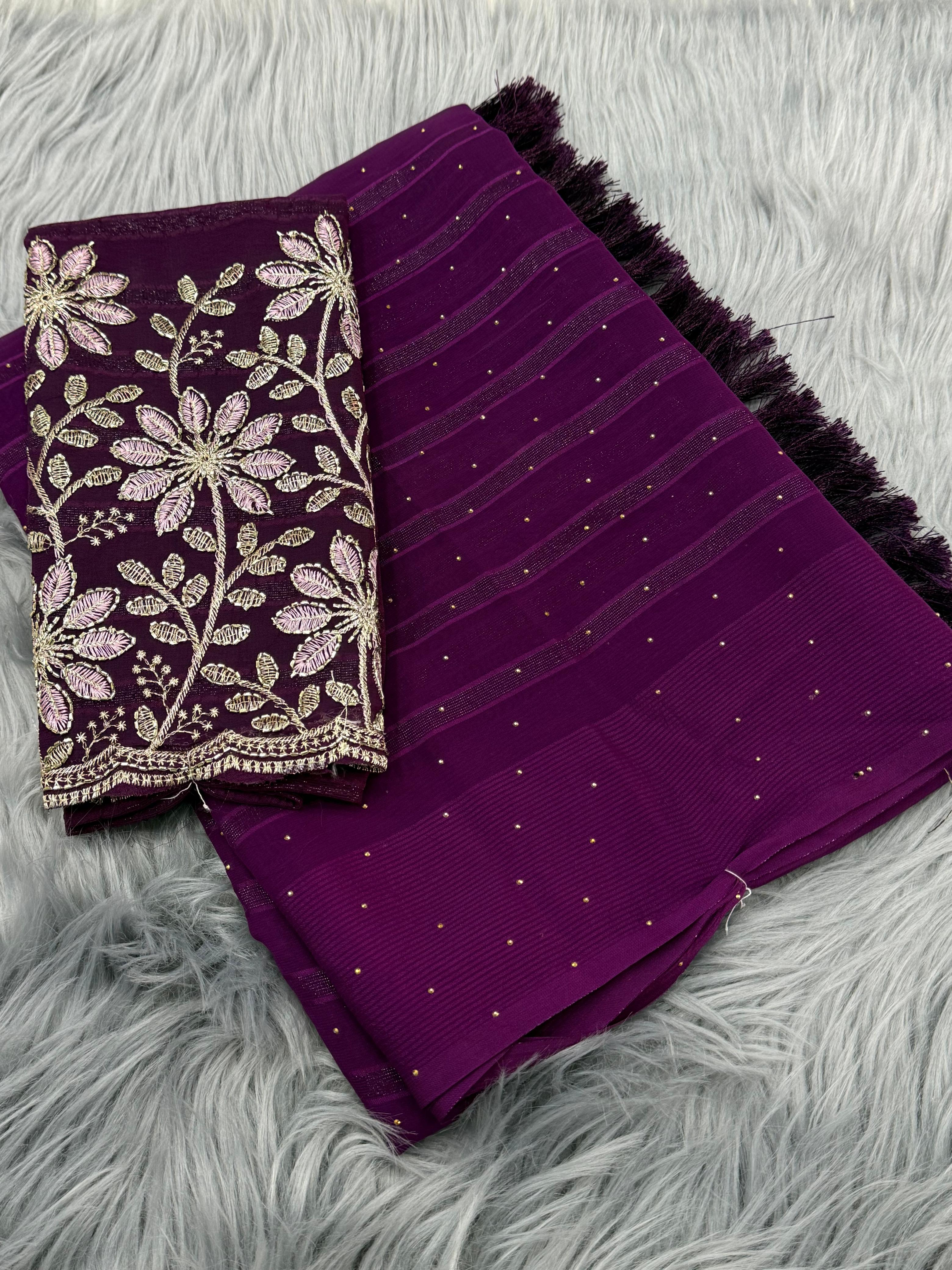 Purple fabric with floral embroidery on a gray textured surface