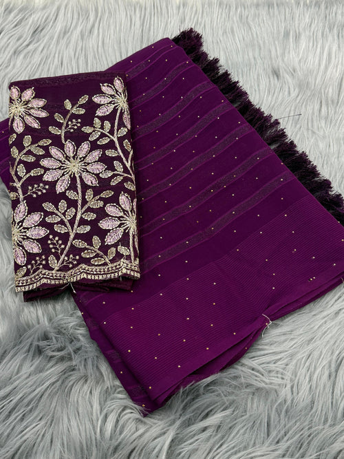 Purple fabric with floral embroidery on a gray textured surface