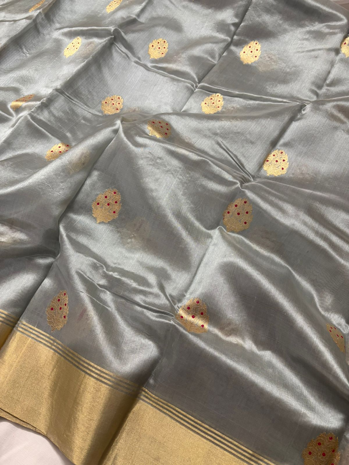 Gray fabric with gold patterns and border