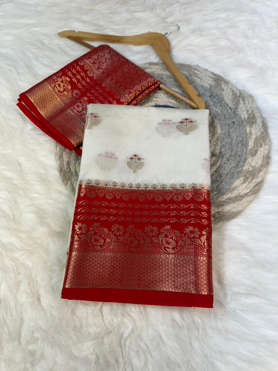 Red and white embroidered fabric on a wooden hanger against a white background