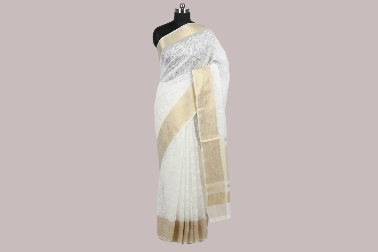 White fabric with gold border on a red surface