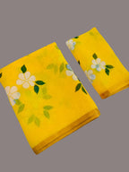 Two yellow fabric items with floral patterns on a gray background