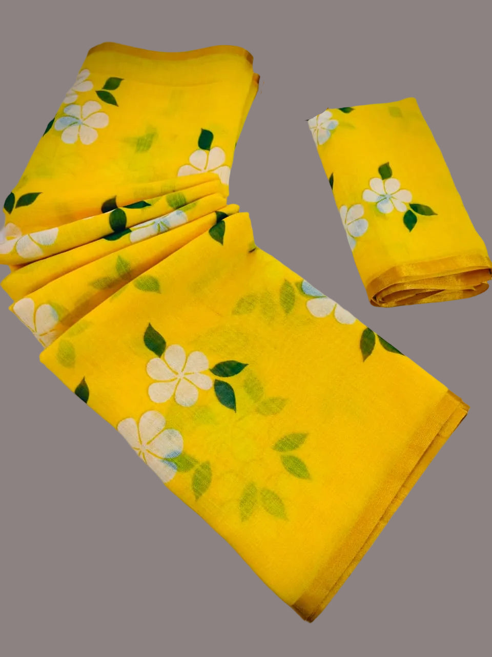 Yellow fabric with floral patterns on a gray background