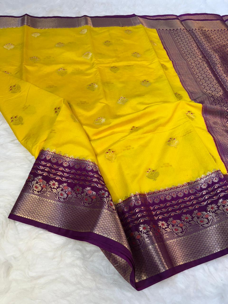 Yellow saree with purple border on a white background